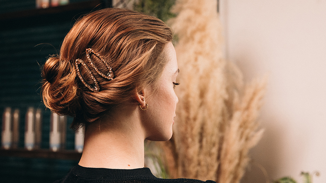 picture of a low bun with sparkly hair clips